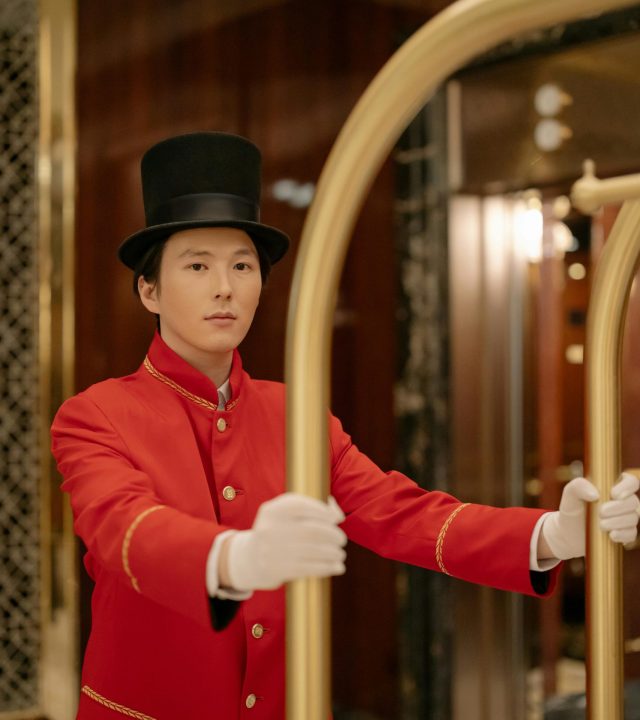 Man in Red Uniform Pushing a Cart